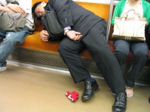 Salaryman asleep on the Tokyo Subway.jpg