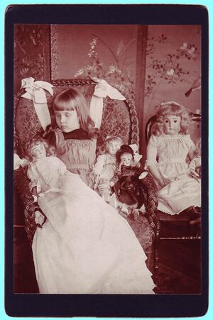 A young girl with four dolls.jpg